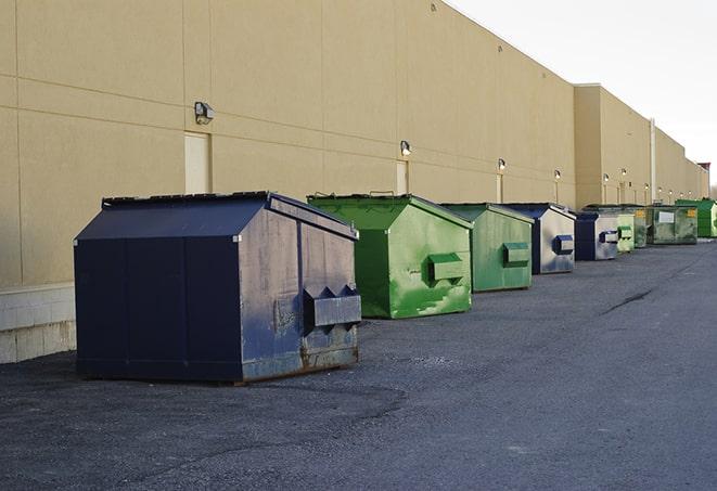 workers clearing construction waste into dumpsters in Altadena